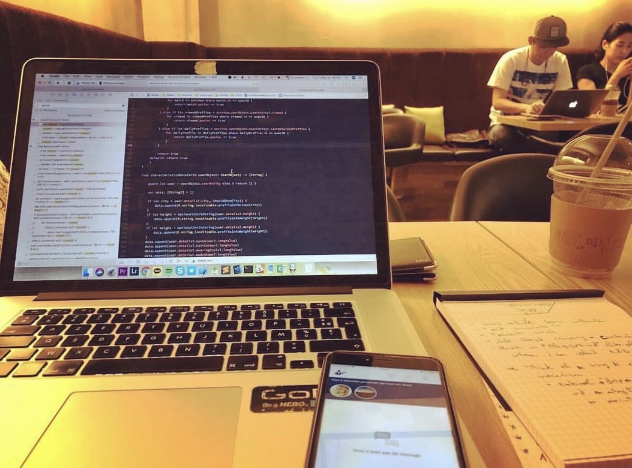 The build in progress: training code on the laptop, the ordering app running on the phone next to it